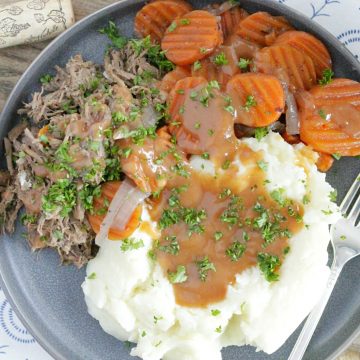 slow cooker red wine pot roast with carrots and mashed potatoes and gravy