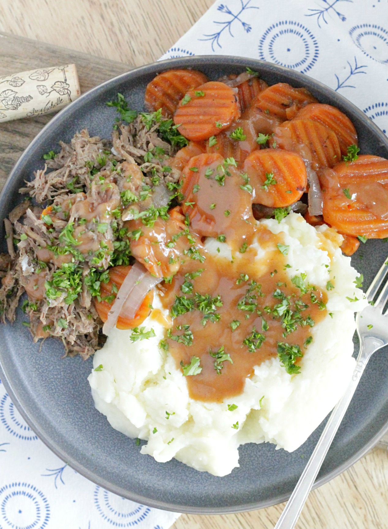 slow cooker red wine pot roast with carrots and mashed potatoes and gravy