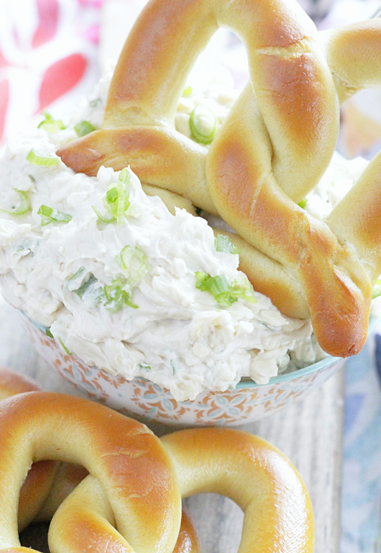 Guinness cheddar dip pictured in a bowl with soft baked pretzels