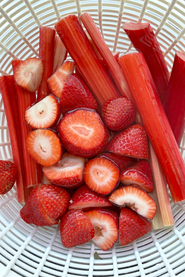 bright red strawberries and stalks of rhubarb