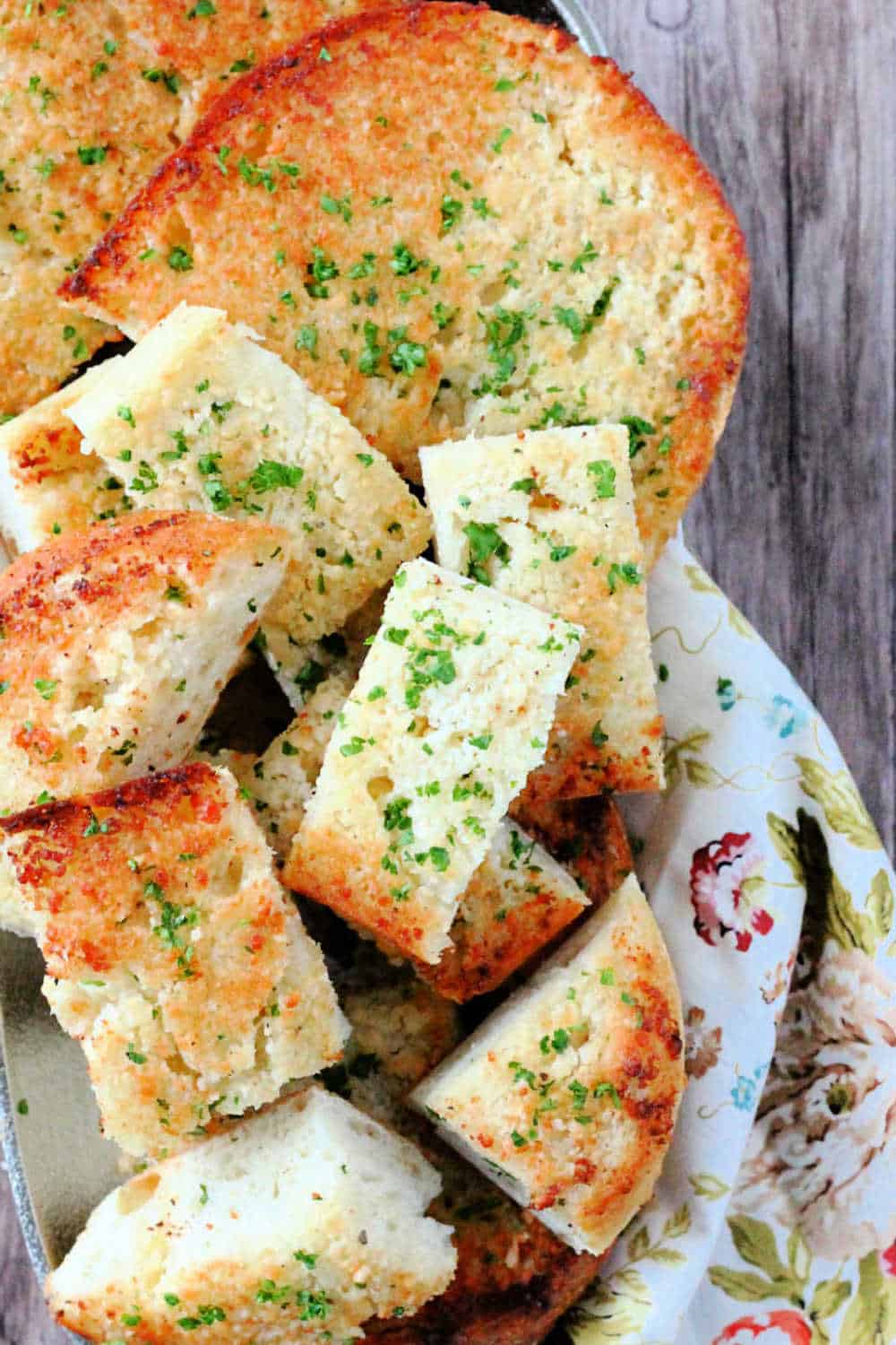 Dry toasting garlic cloves before mixing them with softened butter and Parmesan cheese makes this the best artisan garlic bread recipe. via @foodtasticmom
