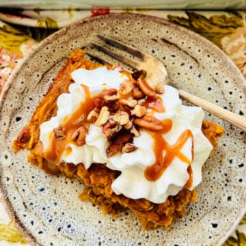 a slice of pumpkin pie baked oatmeal topped with whipped cream