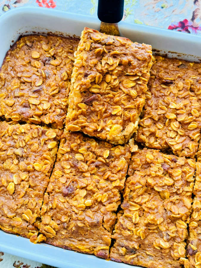 a freshly baked dish of pumpkin pie baked oatmeal sliced and ready to serve