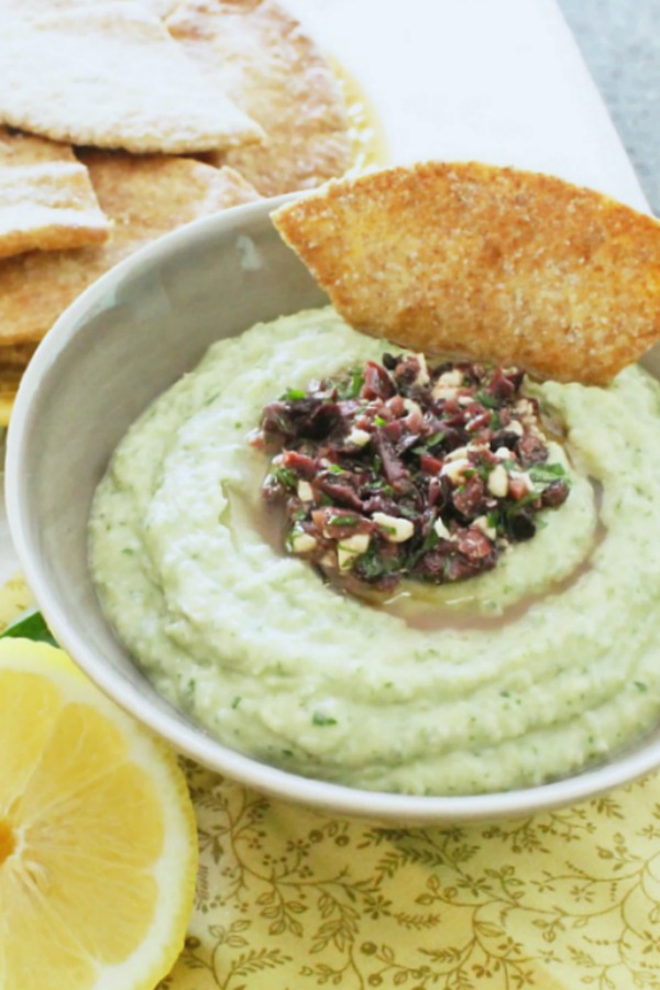 lemony white bean hummus in bowl with pita chips