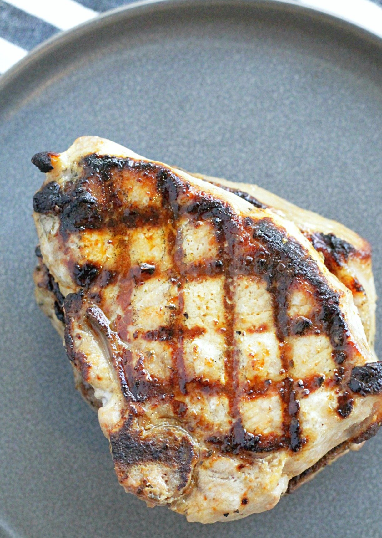 single pork chops on a grey plate