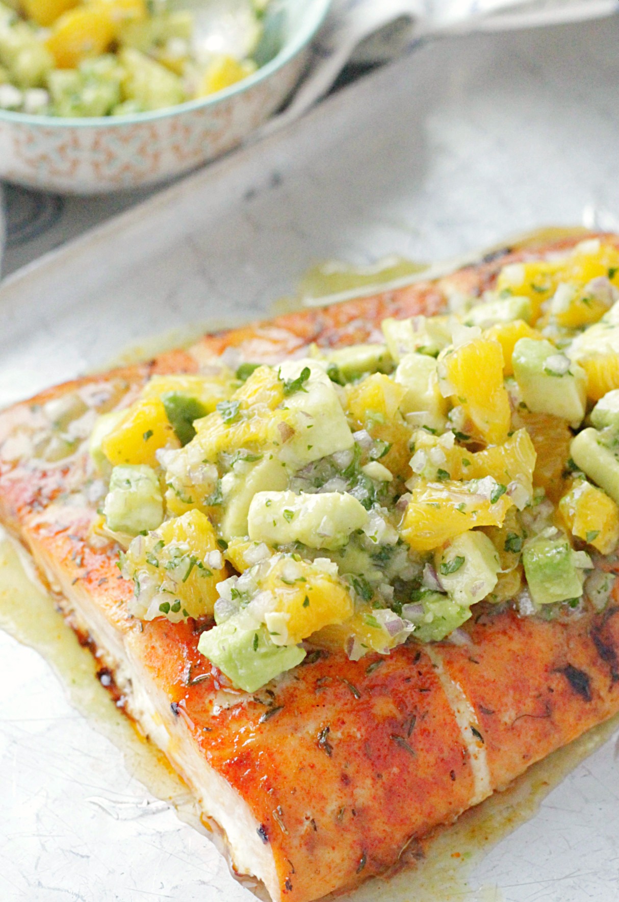 Side view of citrus salmon on silver tray