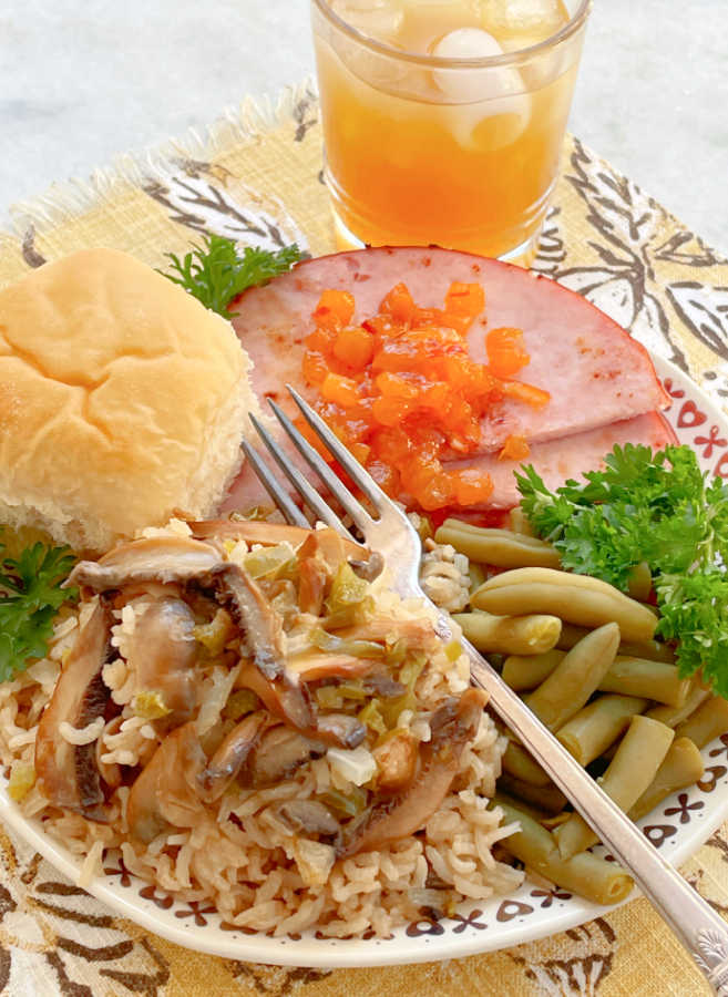 rice pilaf on a plate with ham and green beans