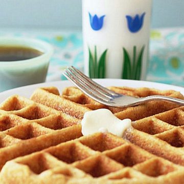whole grain waffle on plate with glass of milk