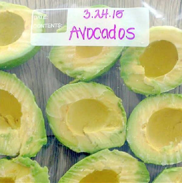 showing frozen avocado halves in a freezer bag