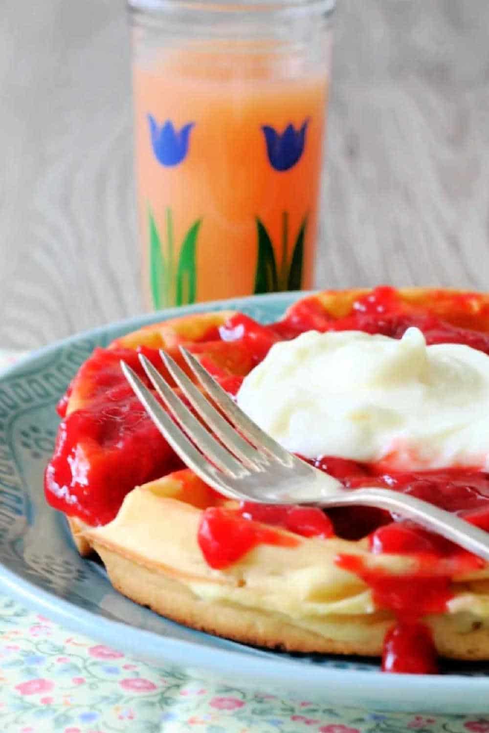 Strawberry cheesecake waffles starts with a homemade buttermilk waffle topped with fresh strawberry sauce and cream cheese topping. via @foodtasticmom