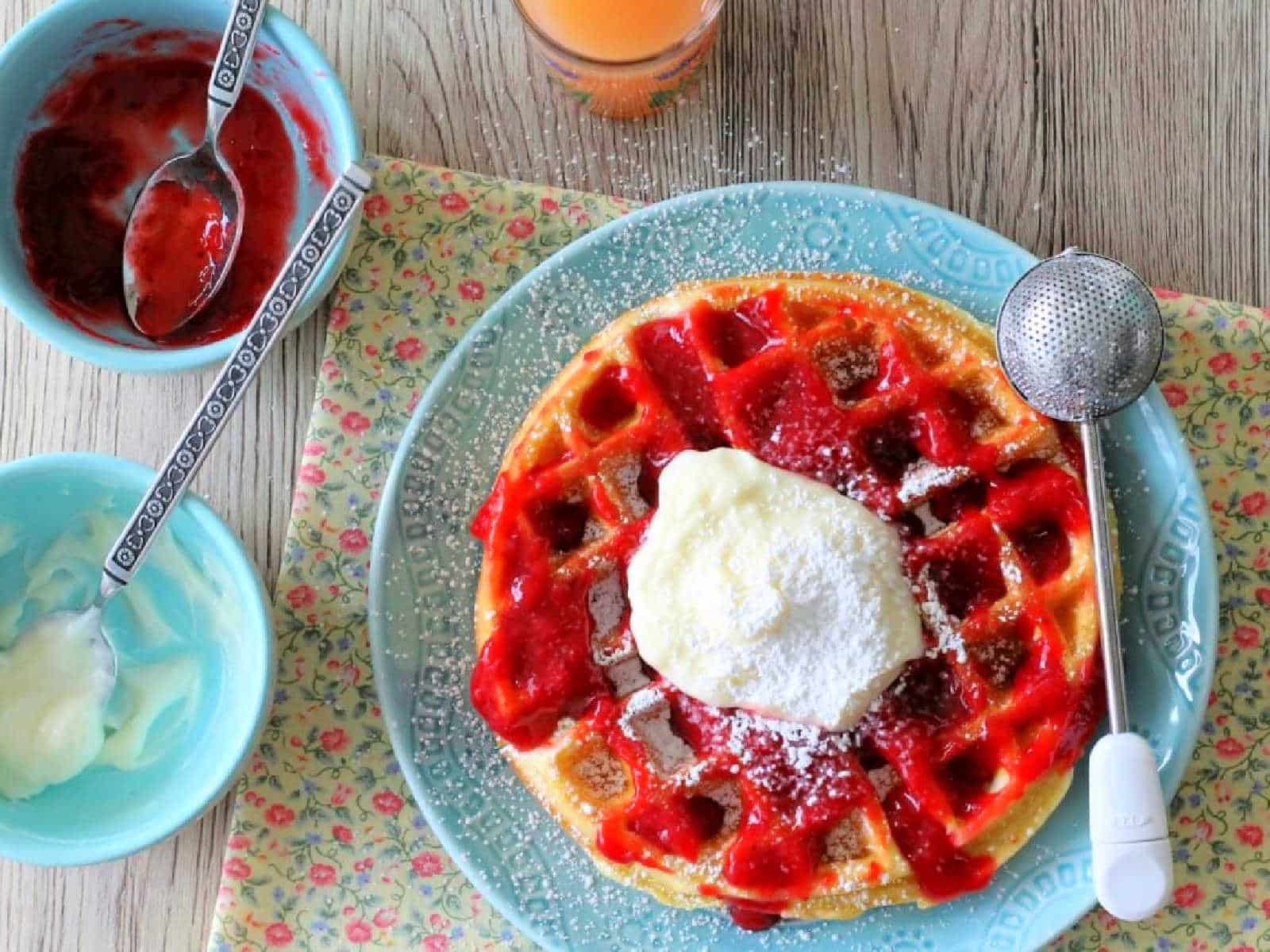 plated waffle with a glass of grapefruit juice on the side