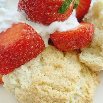 strawberry shortcake on a plate with whipped cream