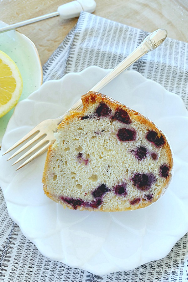 slice of blueberry bundt cake on plate with fork