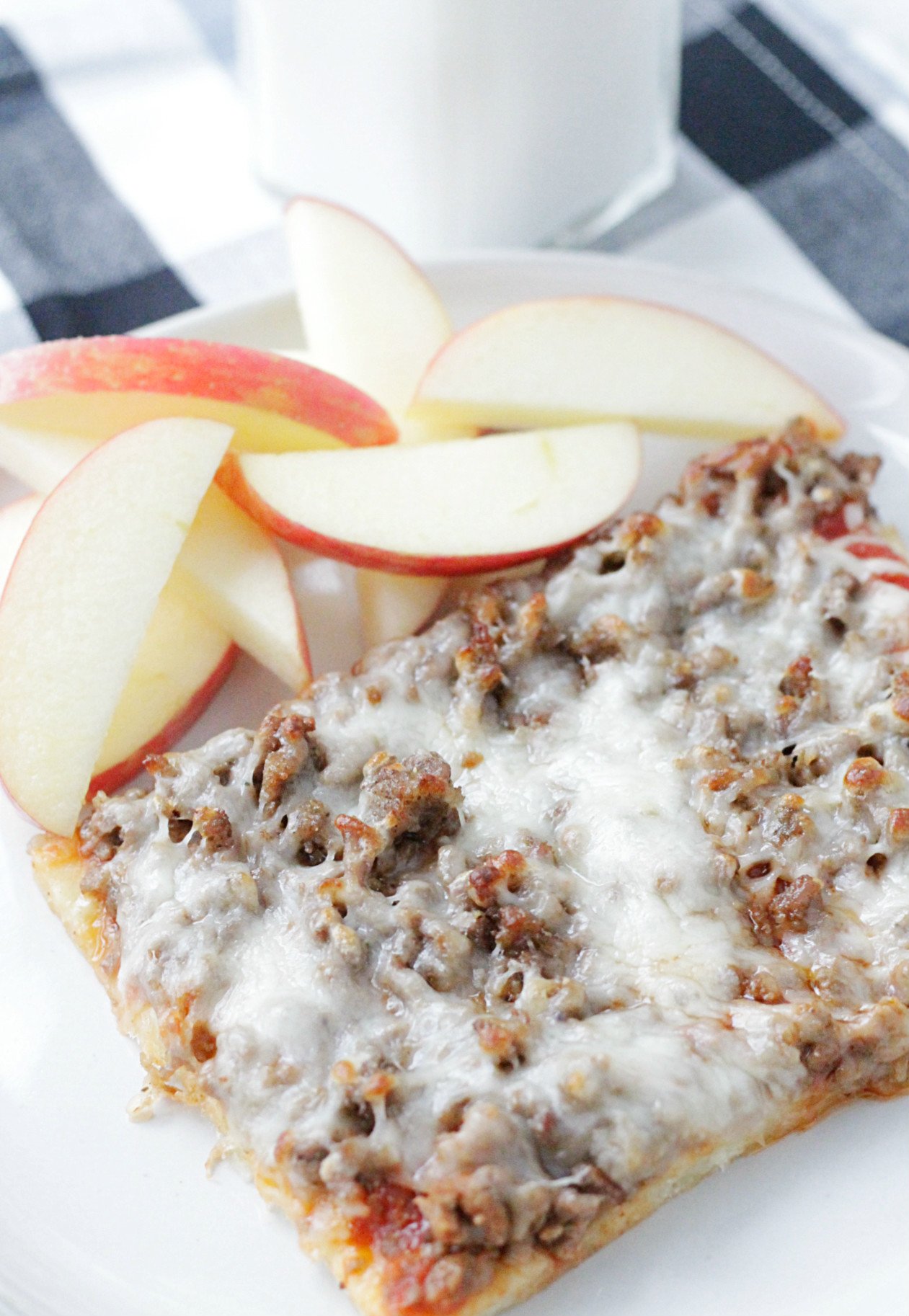 school lunch pizza on a plate with apple slices