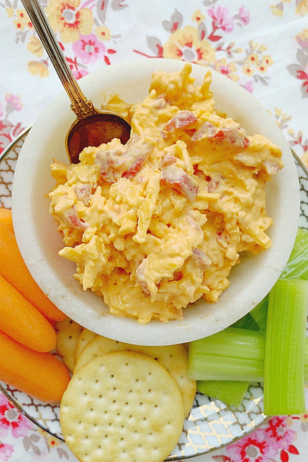 overhead view of pimento cheese with crackers, carrots and celery