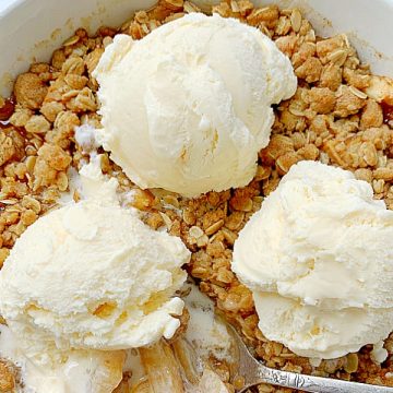 a whole recipe of apple crisp topped with three scoops of vanilla ice cream