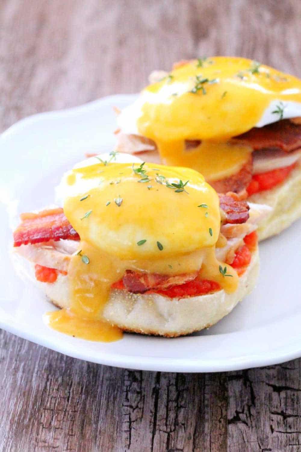 Kentucky Hot Brown Eggs Benedict combines the best parts of Kentucky's most famous sandwich (tomato, bacon, turkey and cheese sauce) and combines them with a traditional eggs Benedict. via @foodtasticmom