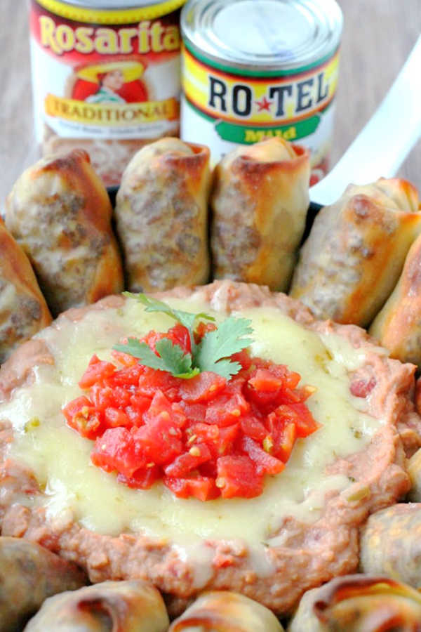 skillet bean dip pictured with cans of rotel tomatoes and rosarita refried beans