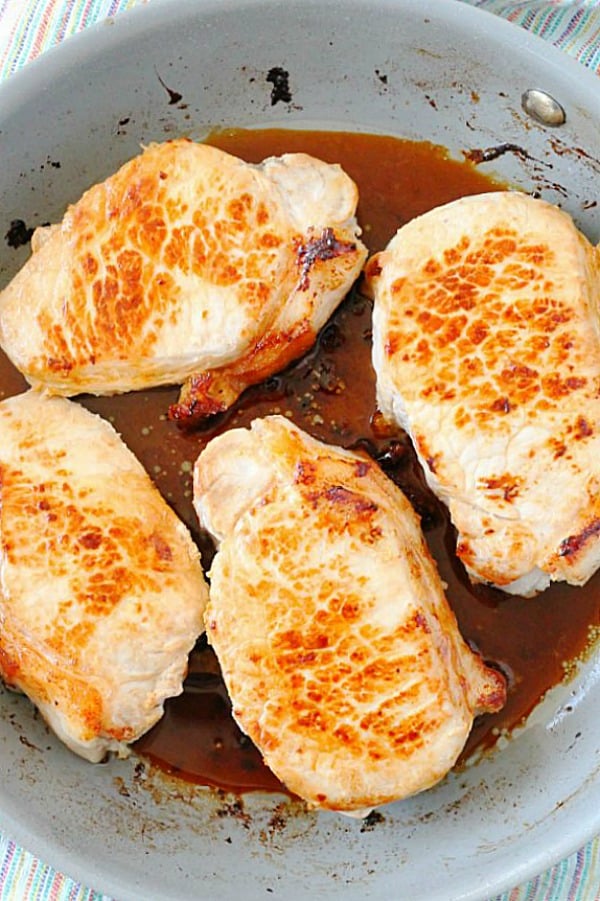 seared pork chops in skillet