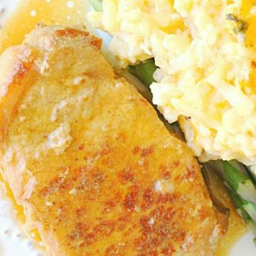 slow cooker pork chops on plate with cheesy potatoes