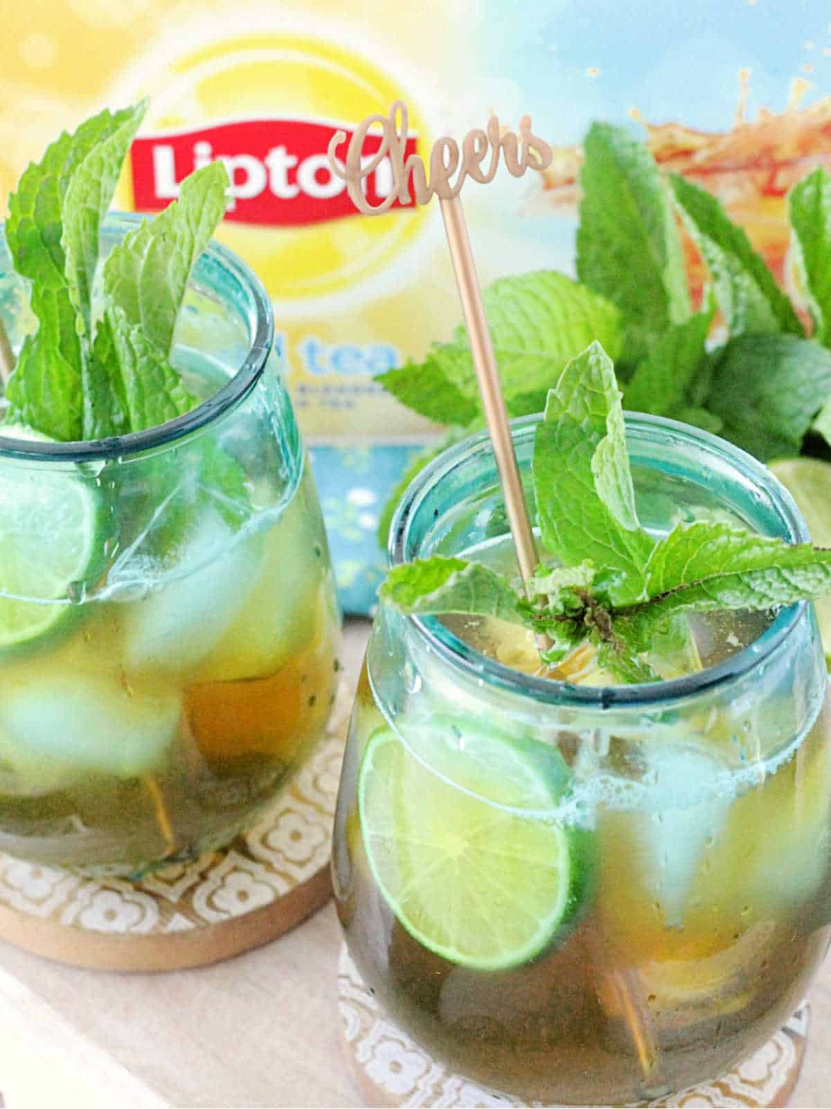 two glasses of mojito iced tea displayed in front of a Lipton iced tea box