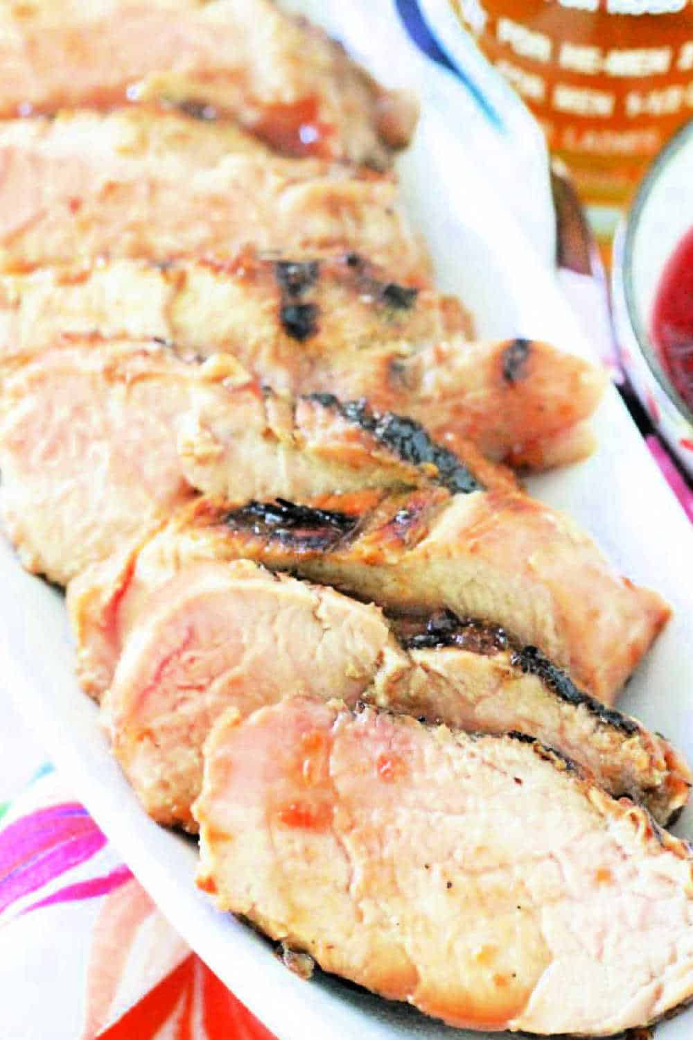 Grilled cherry bourbon glazed pork tenderloin is a surprisingly quick and easy meal to make. Includes video tutorial. via @foodtasticmom