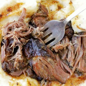 slow cooker short ribs overhead shot on bed of mashed potatoes with gravy