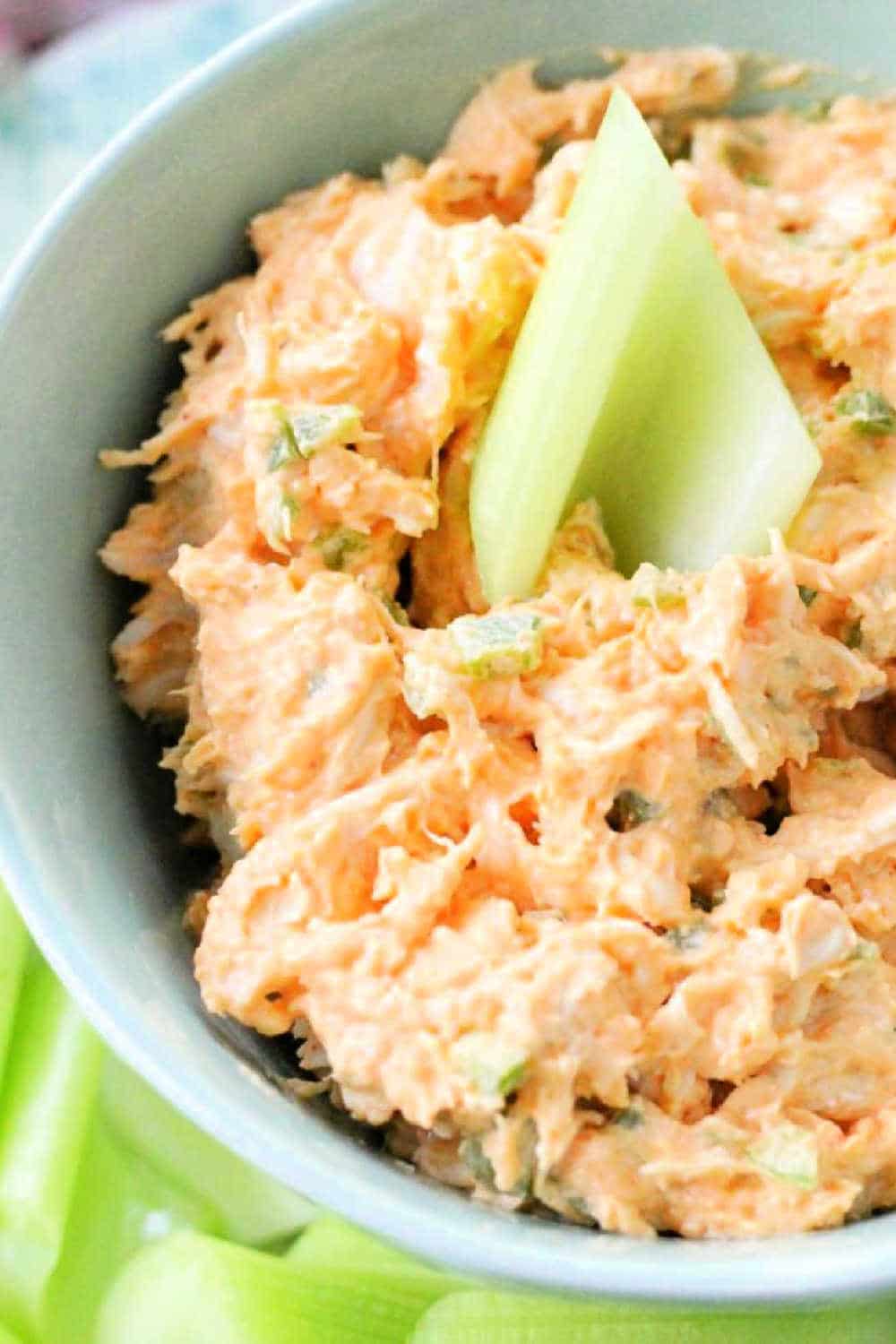 This healthier buffalo chicken dip is served cold to be a delicious dip for fresh celery. It's got a creamy texture and spicy kick. via @foodtasticmom