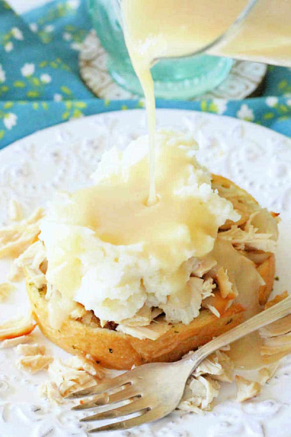 Slow Cooker Turkey Hot Shot piles slow cooked turkey and gravy atop mashed potatoes and thick slices of garlic bread. The ultimate open faced sandwich. via @foodtasticmom