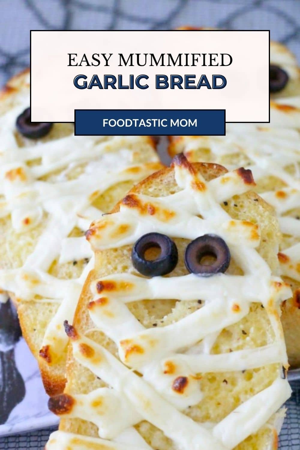 My mummified garlic bread recipe turns homemade garlic bread into a spooky side dish. With string cheese bandages and black olive eyes. via @foodtasticmom