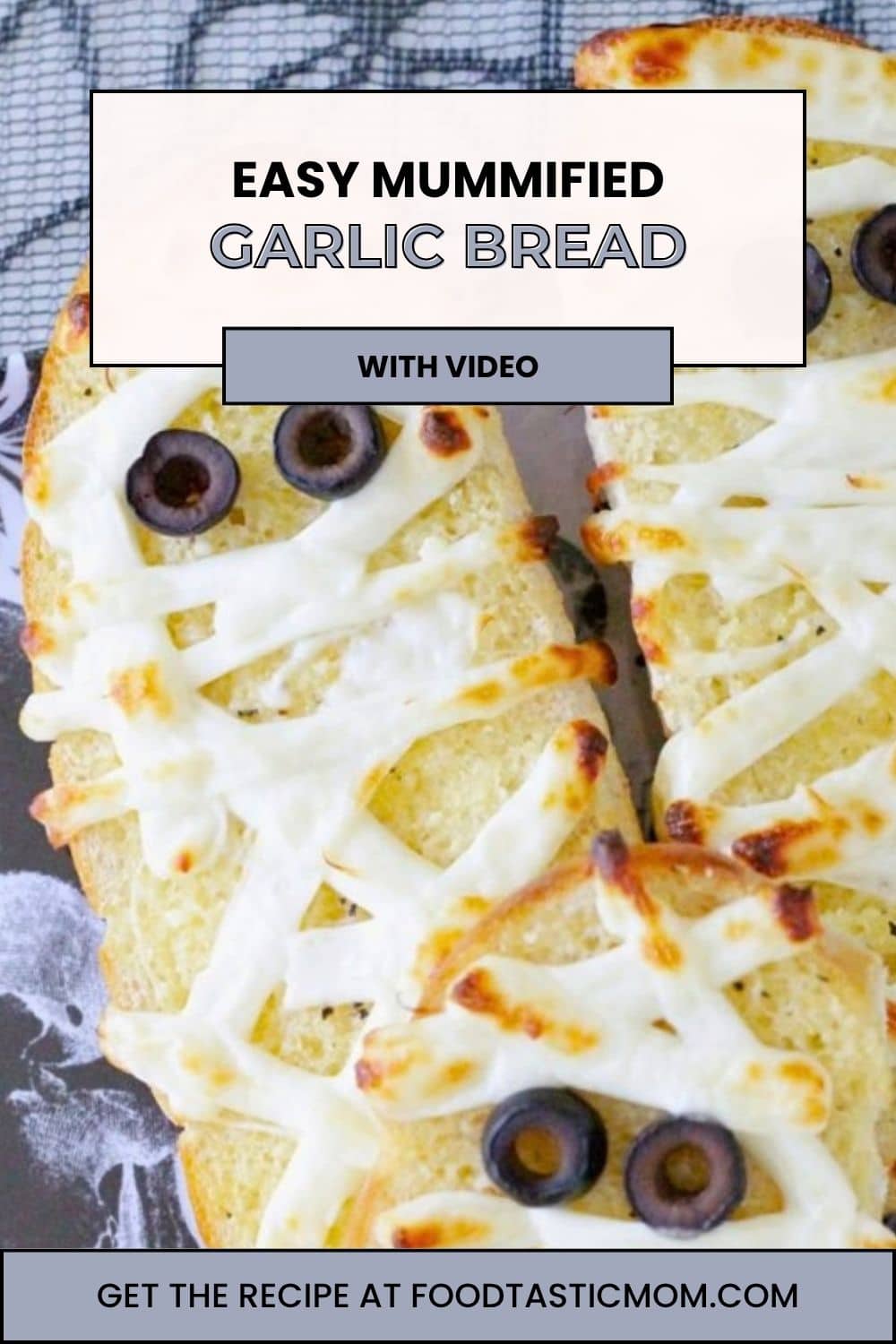 My mummified garlic bread recipe turns homemade garlic bread into a spooky side dish. With string cheese bandages and black olive eyes. via @foodtasticmom