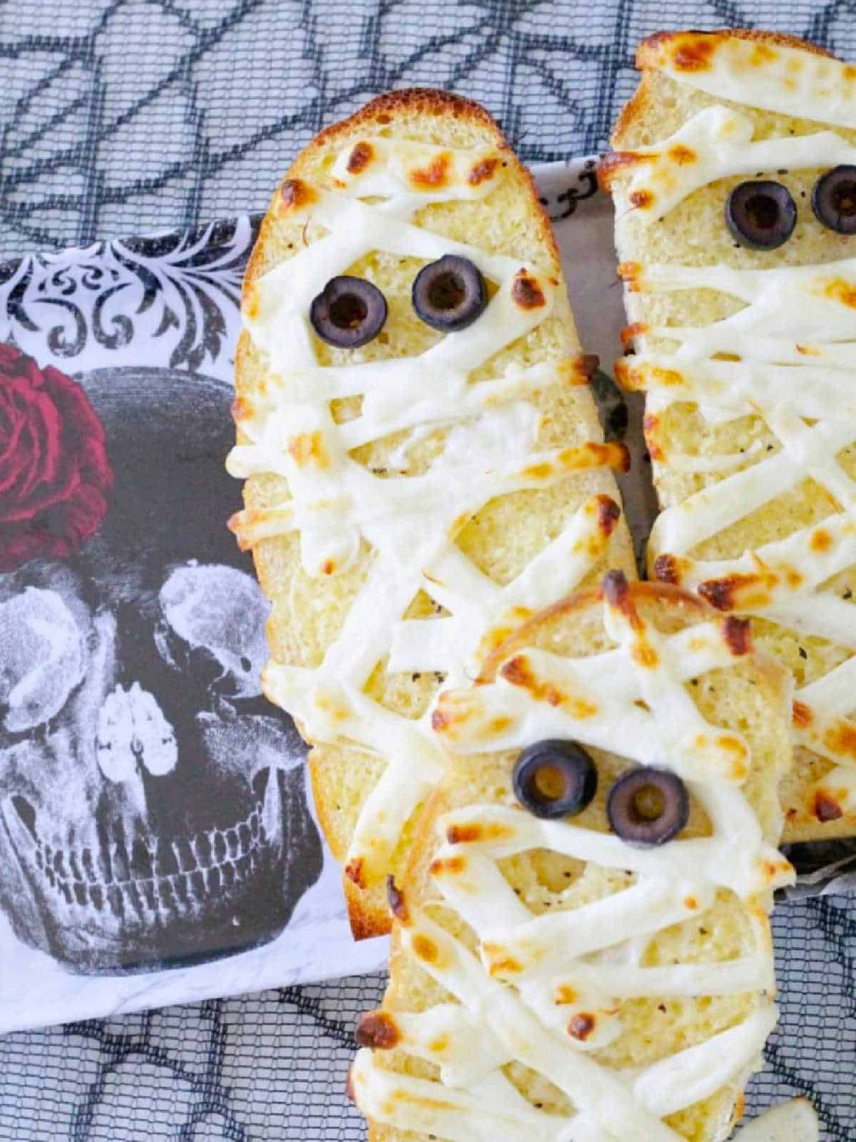three plated slices of mummy garlic bread