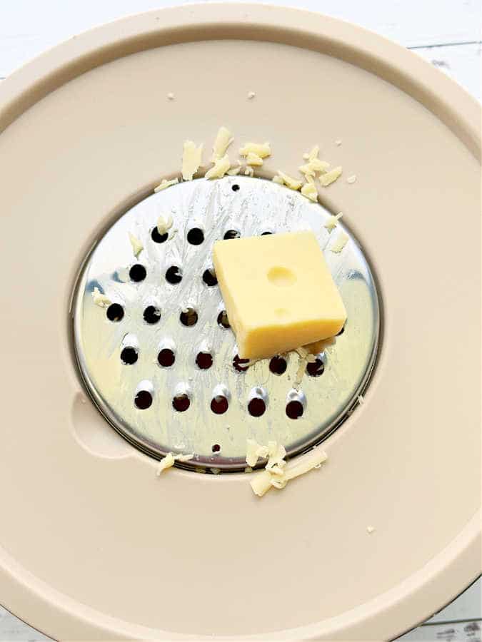 grating the Jarlsberg cheese into a bowl