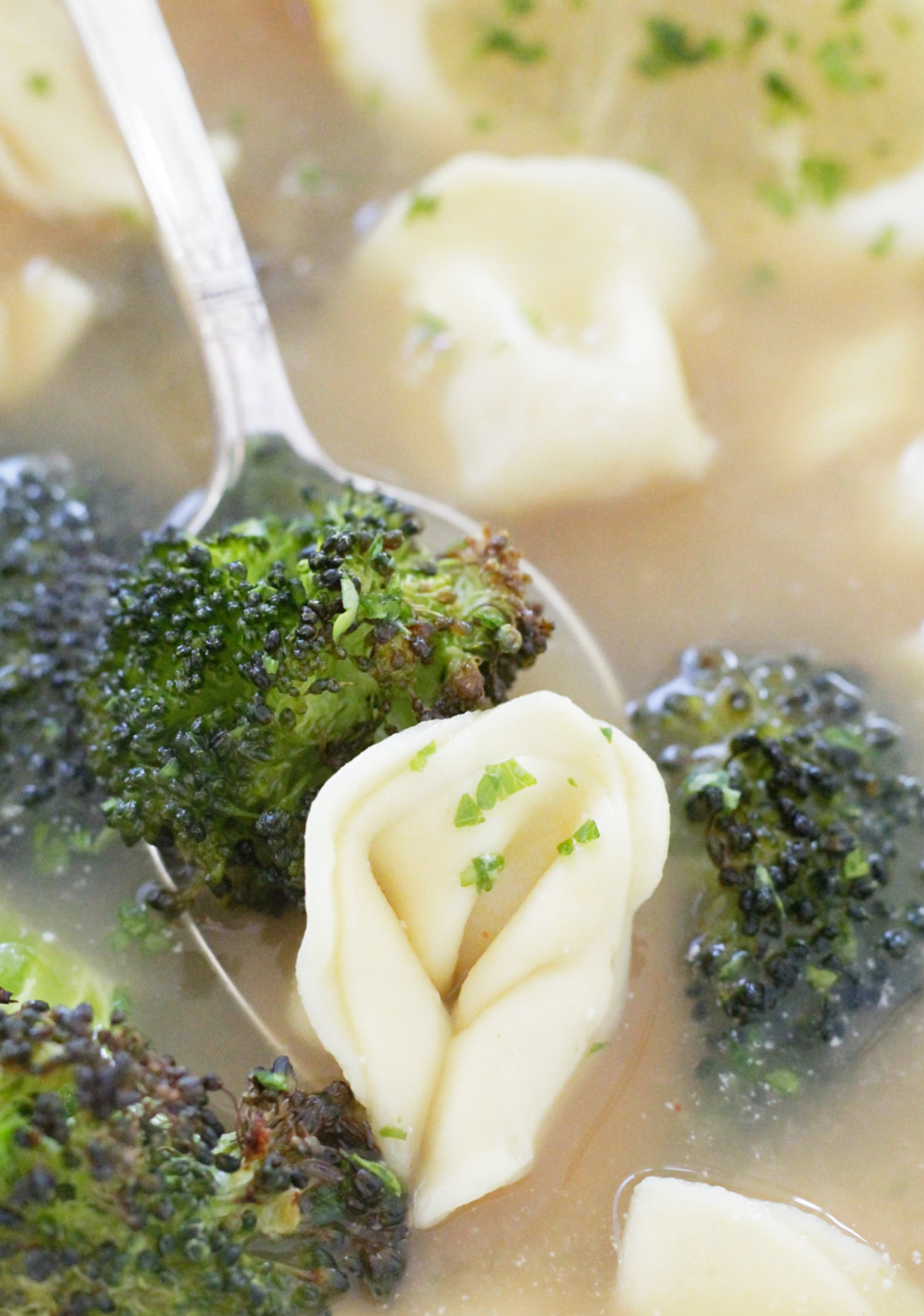 close up view of tortellini broth bowl