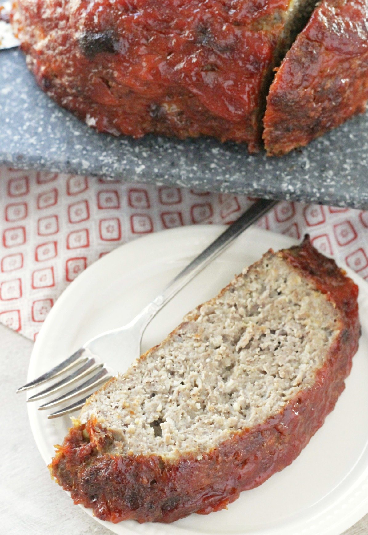 slice of meatloaf in front of cutting board