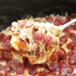 pizza dip in slow cooker with spoon