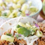 pork tacos with bowl of pineapple salsa