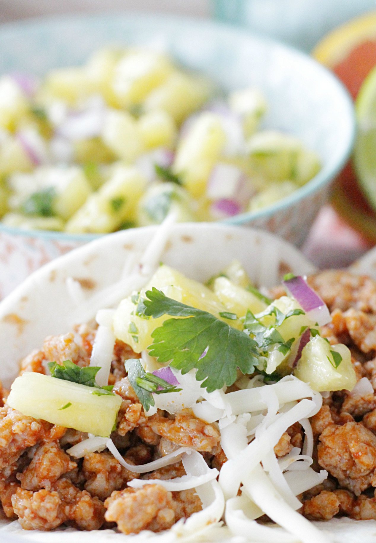 pork tacos with bowl of pineapple salsa