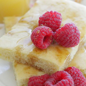 sheet pan pancakes with fresh raspberries and orange juice