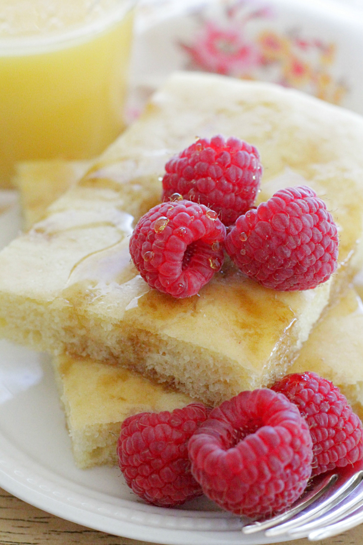 sheet pan pancakes with fresh raspberries and orange juice