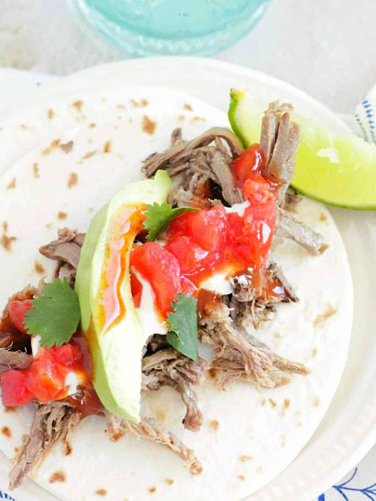 plated beef street taco garnished with lime wedge