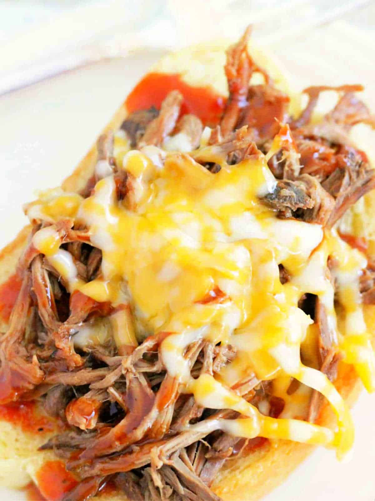 plated open-faced bbq buffalo beef sandwich