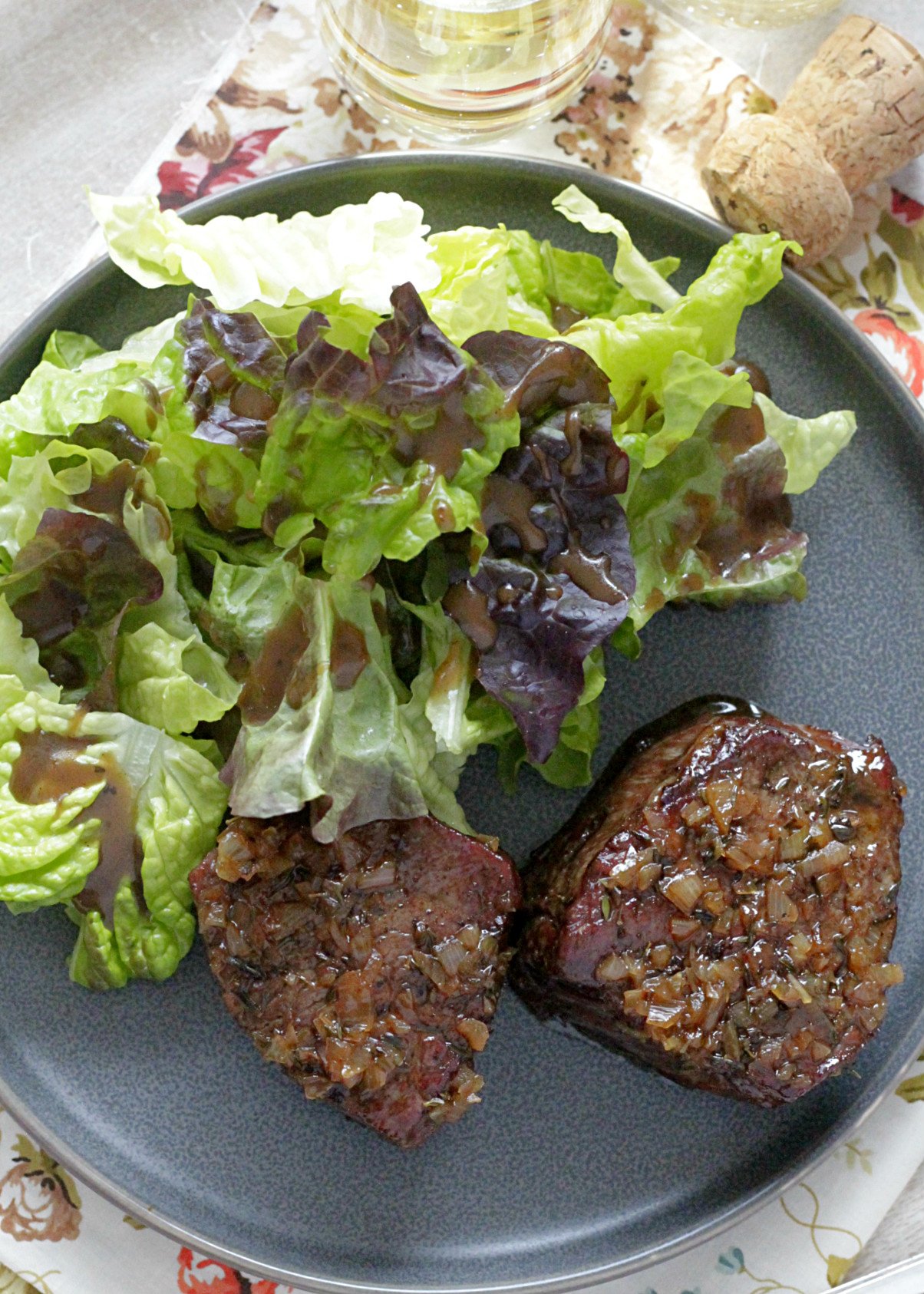 reverse sear filet mignon with champagne butter sauce overhead view with salad and champagne