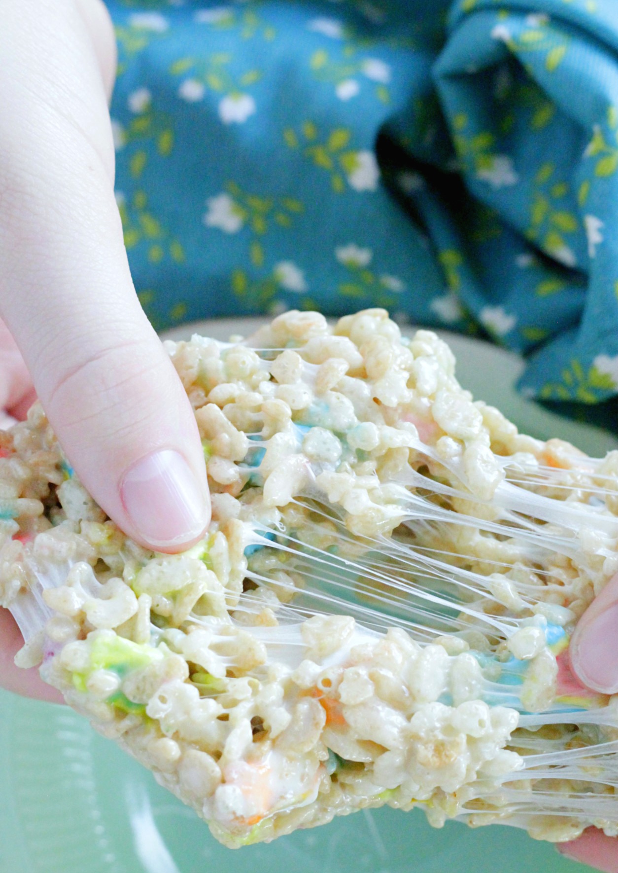 st. patrick's day krispie treat being pulled apart to show the gooey marshmallow