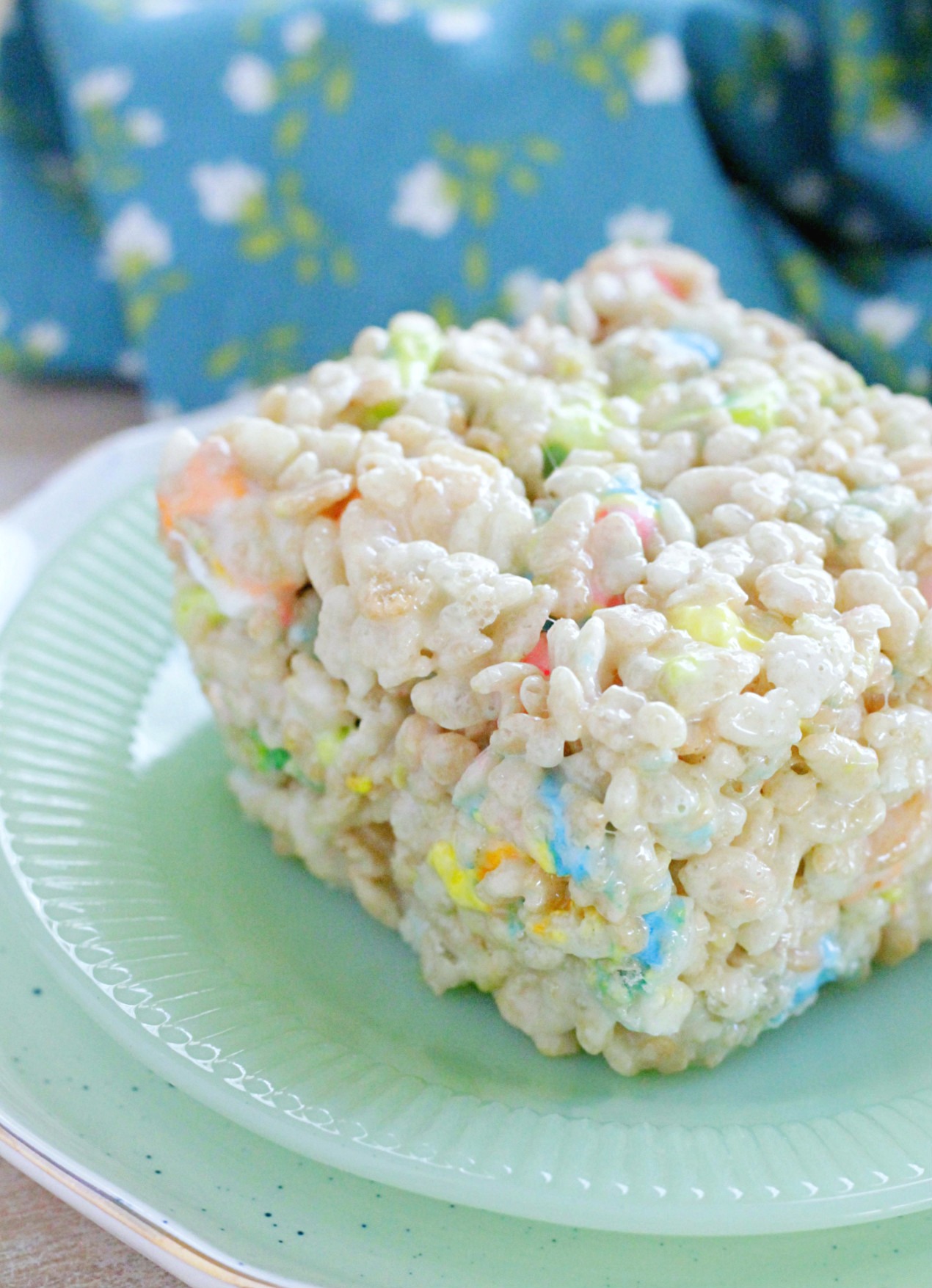 side view of st. patrick's day krispie treat square on a jadeite plate