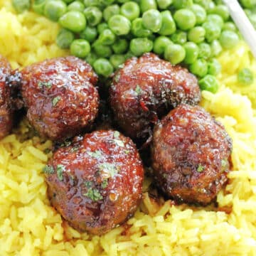 asian maple sausage meatballs plated with yellow rice and peas