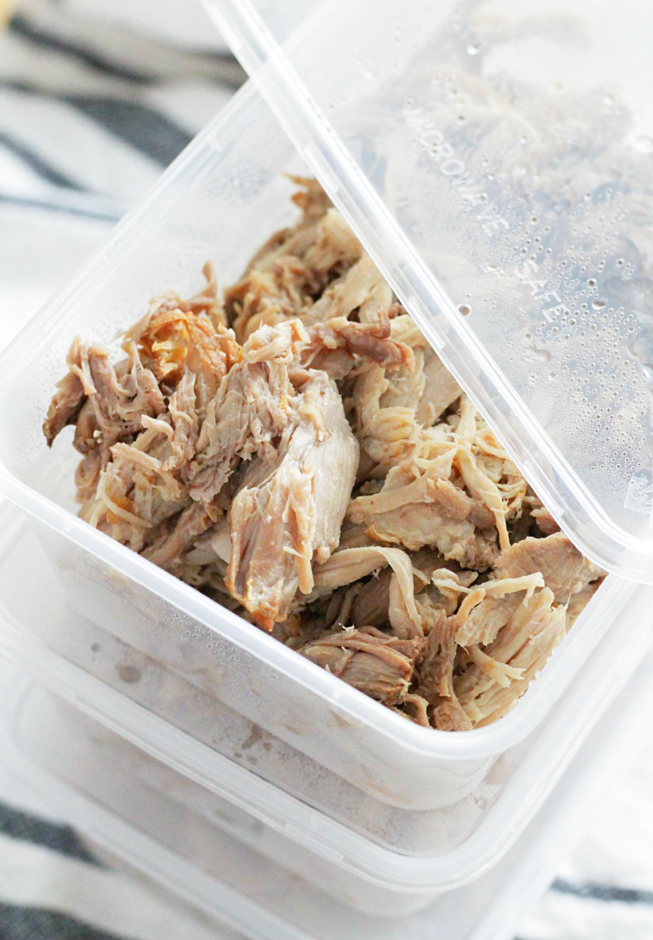 slow cooked pork portioned into individual meal prep containers