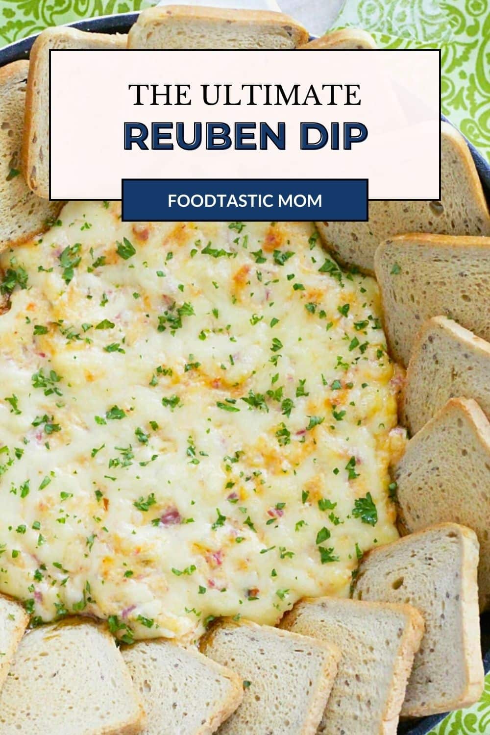 The ultimate reuben dip is baked in a skillet with toasty rye bread squares for dipping. Browning some deli corned beef and finely chopping the sauerkraut plus a couple of unusual mix ins combine for a crowd-pleasing dip based on the classic reuben sandwich. via @foodtasticmom