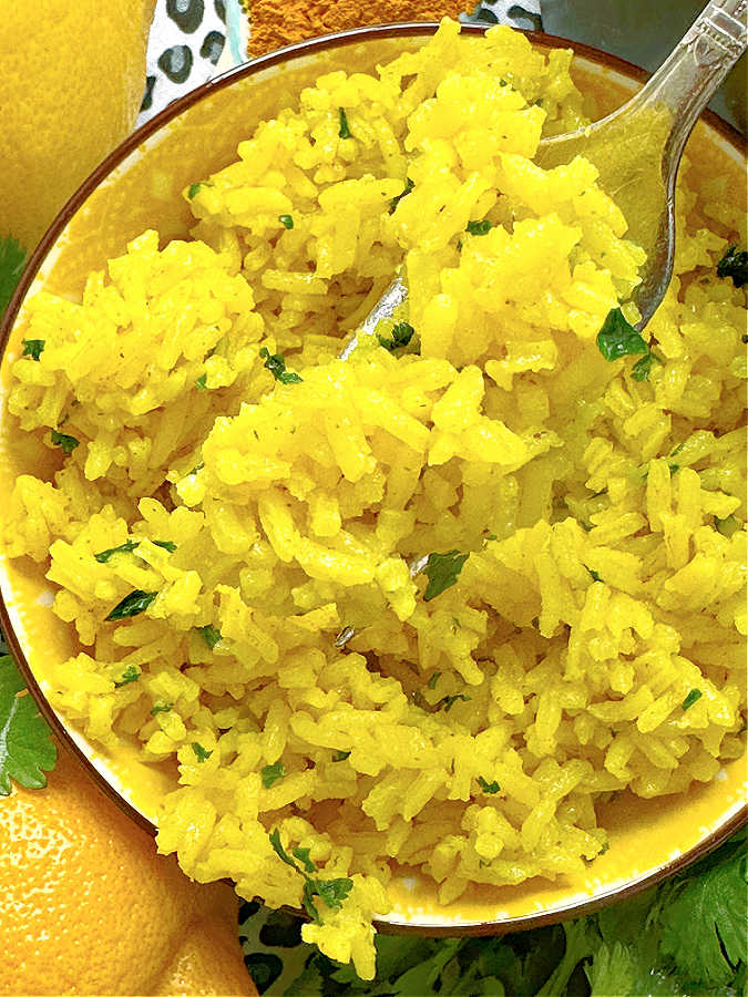 taking a bite of turmeric rice