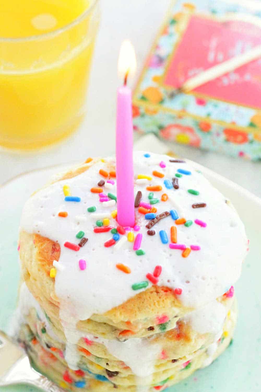 Start the day off right for your loved one with these truly cake-like Birthday Cake Pancakes - loaded with sprinkles and topped with a powdered sugar glaze and birthday candle. via @foodtasticmom
